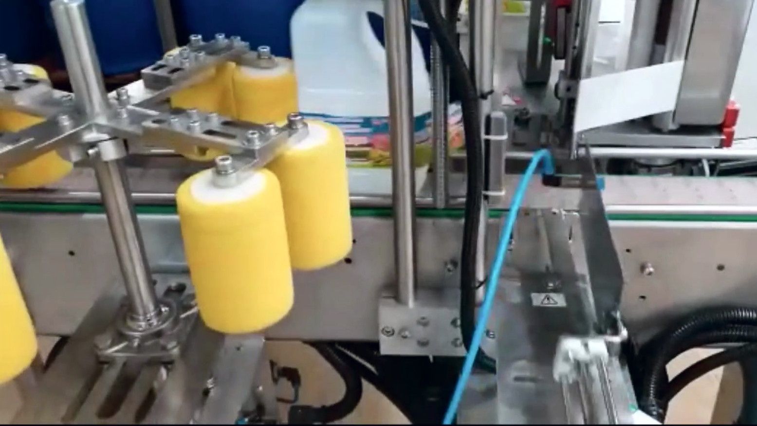 Close-up of a labeling head and label roll on a DDI labeler