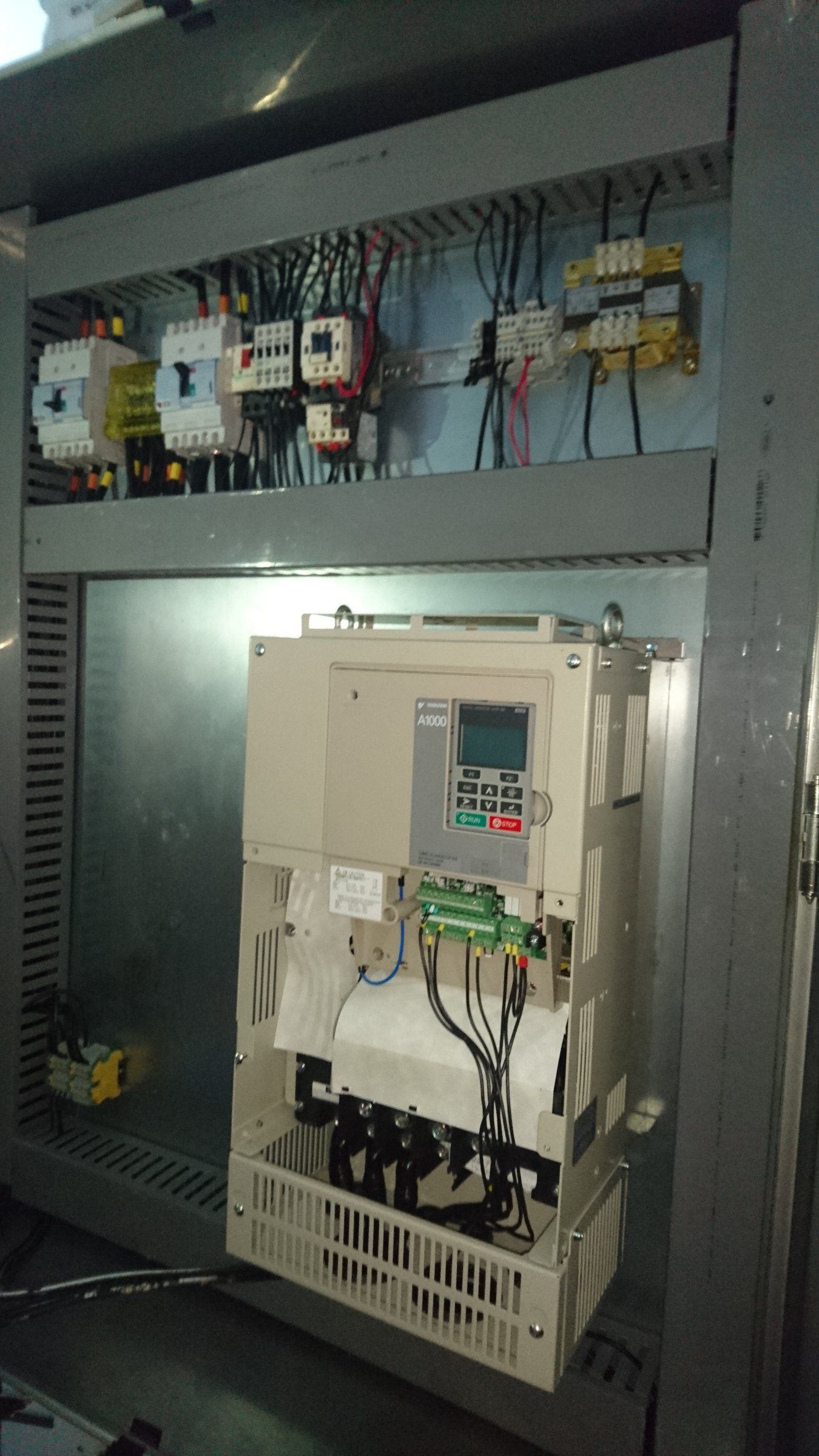 Open control cabinet with a variable-frequency drive and breakers